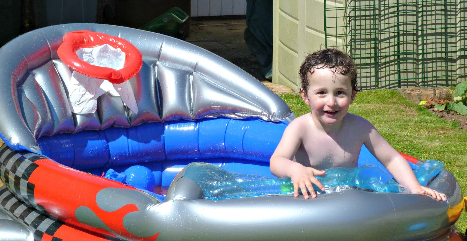 Boy in a paddling pool